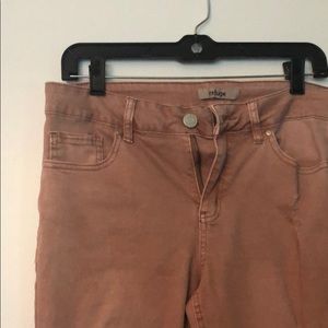 Distressed jeans in a faded pink